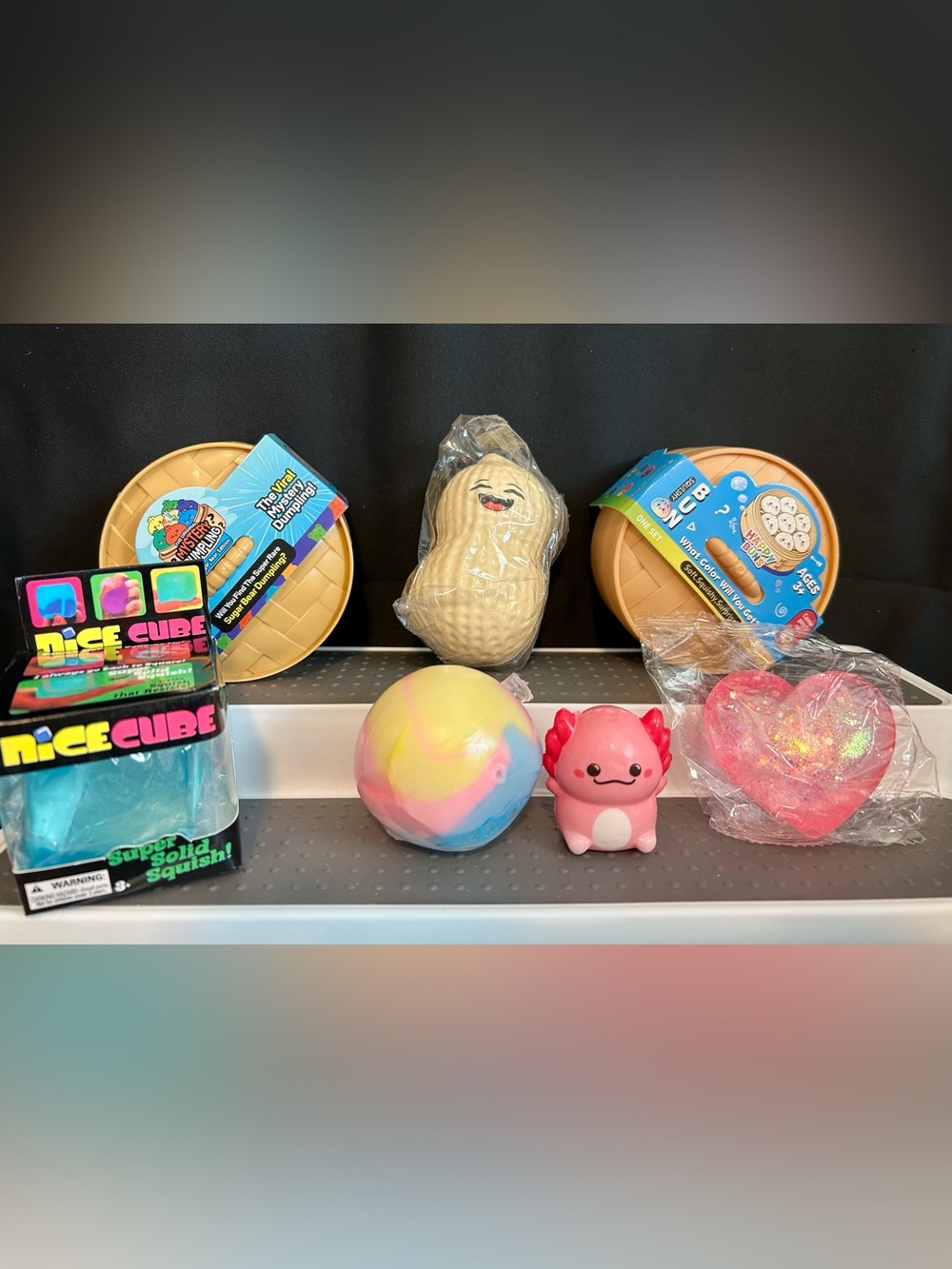 7 squishies including dumplings, cube and axolote